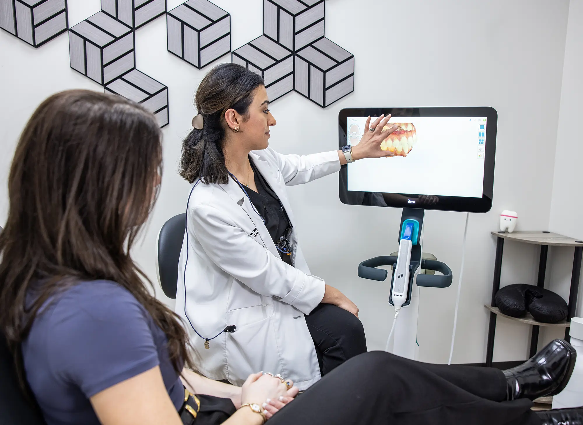 Dentist in Cypress office showing dental scan report to the patient