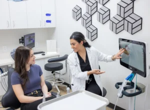 dentist Solmaz Eftekhari showing dental scan to the patient