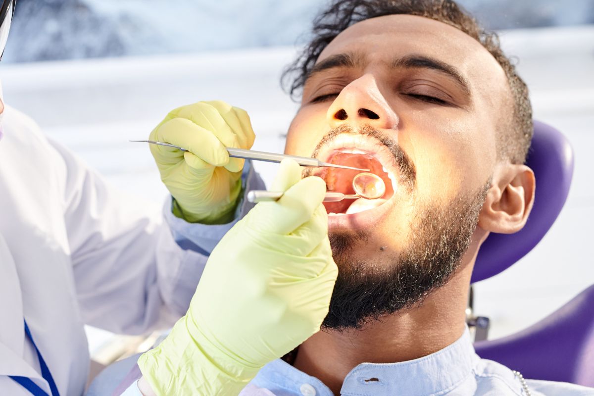 Dentist examining a patient’s teeth during a routine dental visit in Austin Dentist examining a patient's teeth during a routine dental visit in Austin
