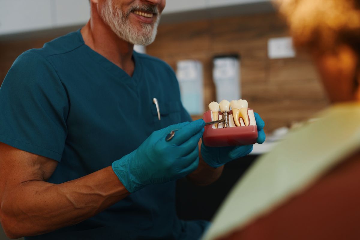 Dentist reviewing tooth replacement options with a patient